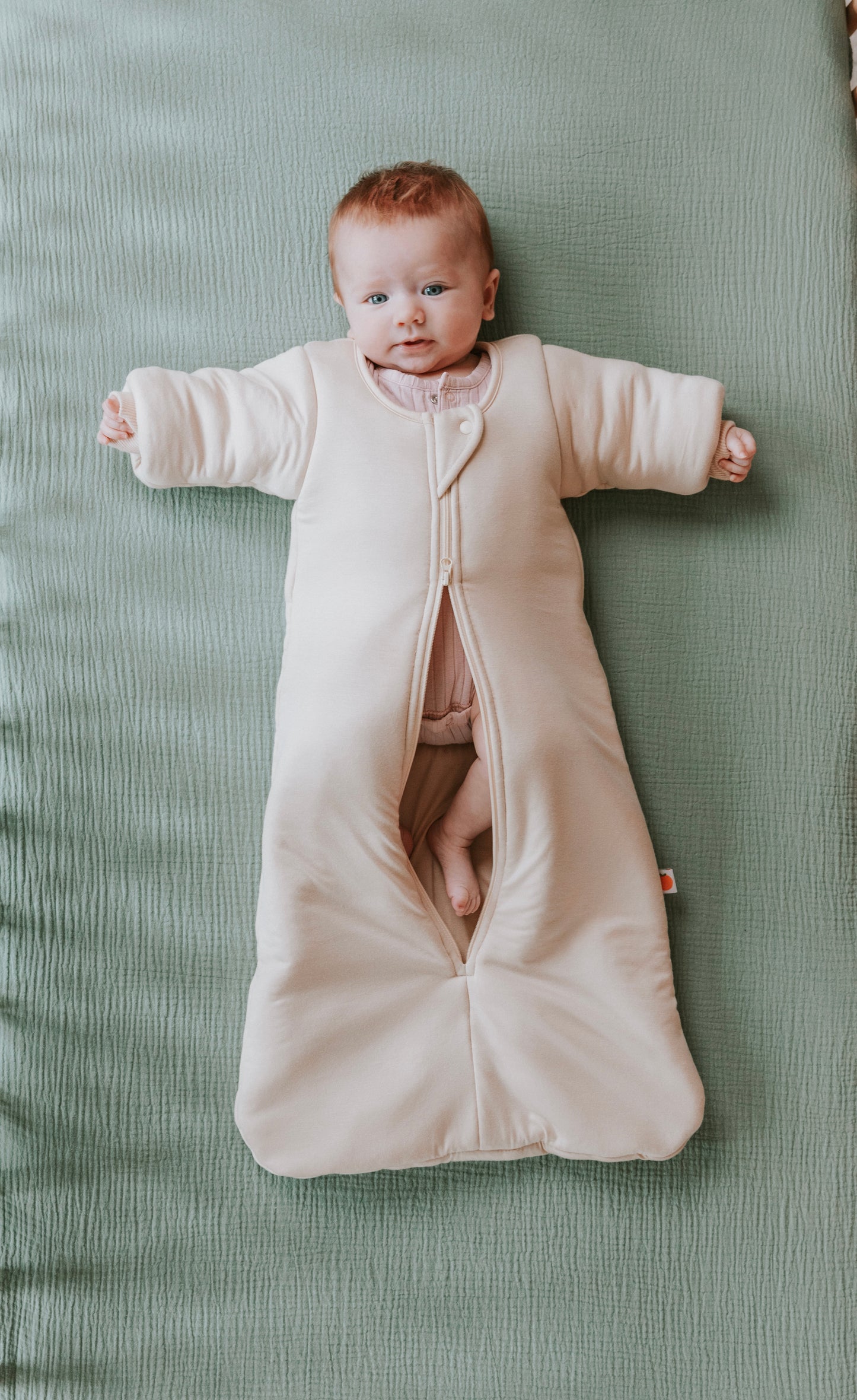 Time to transition out of the swaddle? Then it's time for the Dreamy Peach Co. Transition Sleep Sack! It blunts the startle reflex, while keeping baby safe and cozy. Makes dropping the swaddle a breeze. Double zipper makes for easy diaper changes.