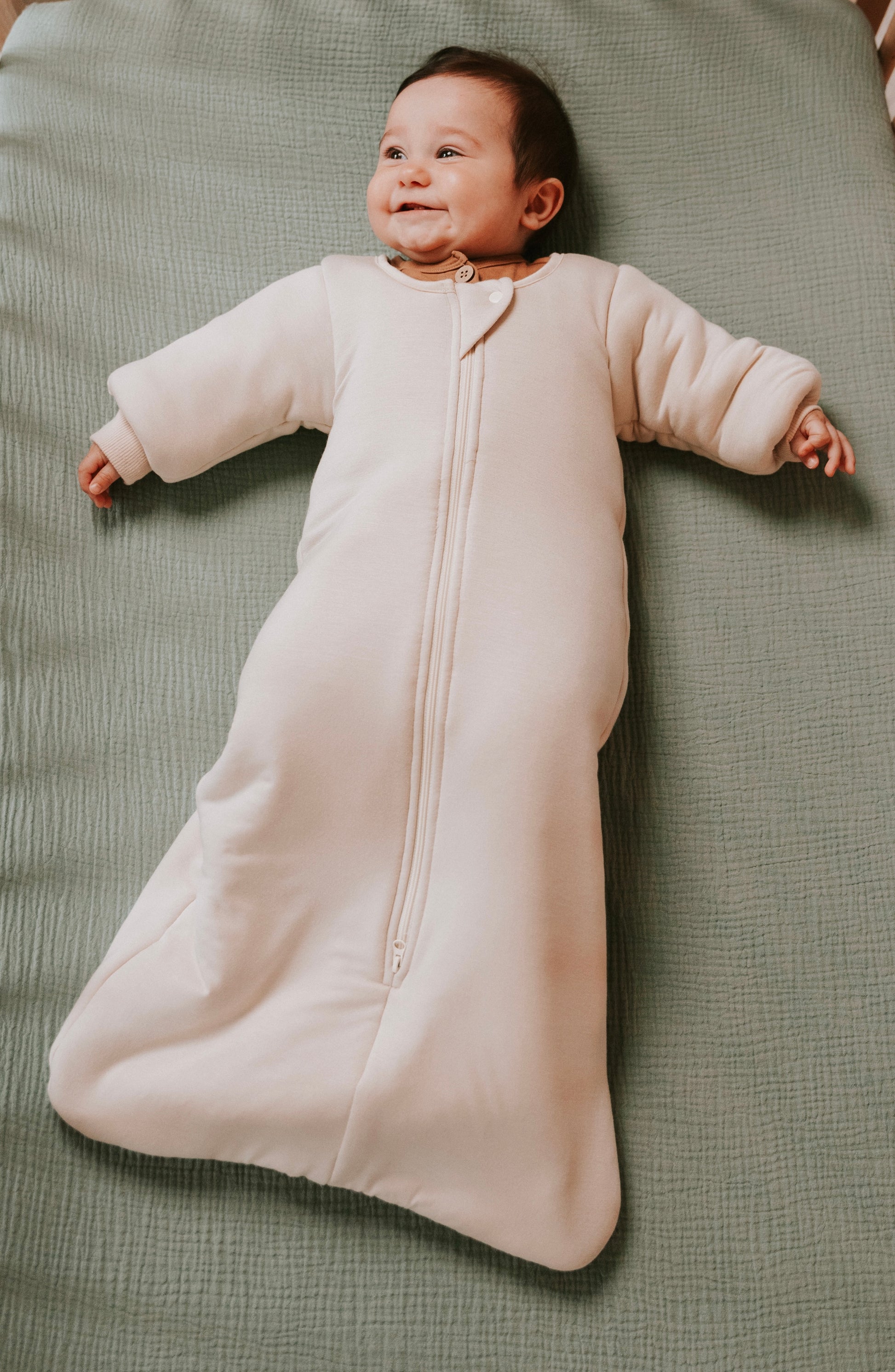 Time to transition out of the swaddle? Then it's time for the Dreamy Peach Co. Transition Sleep Sack! It blunts the startle reflex, while keeping baby safe and cozy. Makes dropping the swaddle a breeze.